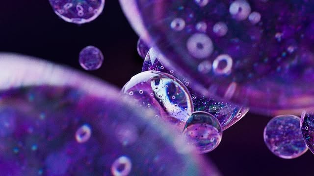 Cluster of translucent iridescent spheres in violet and teal
